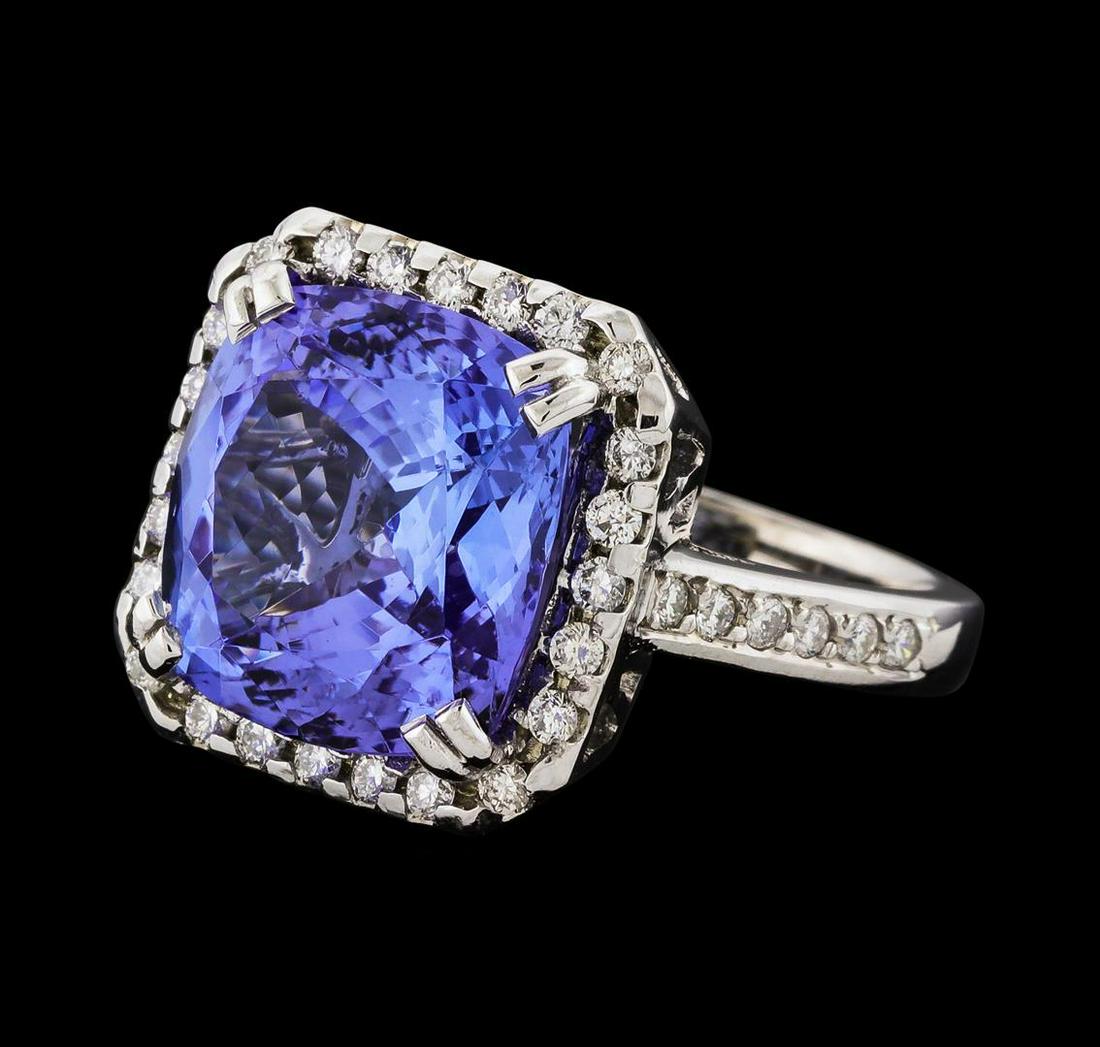 8.27 ctw Tanzanite and Diamond Ring - 14KT White Gold: One electronically tested 14KT white gold lady's cast fashion ring with a cathedral cushion halo with a bright polish finish. The featured lady's ring has a shank measuring 2.67 millimeters wide. Iden