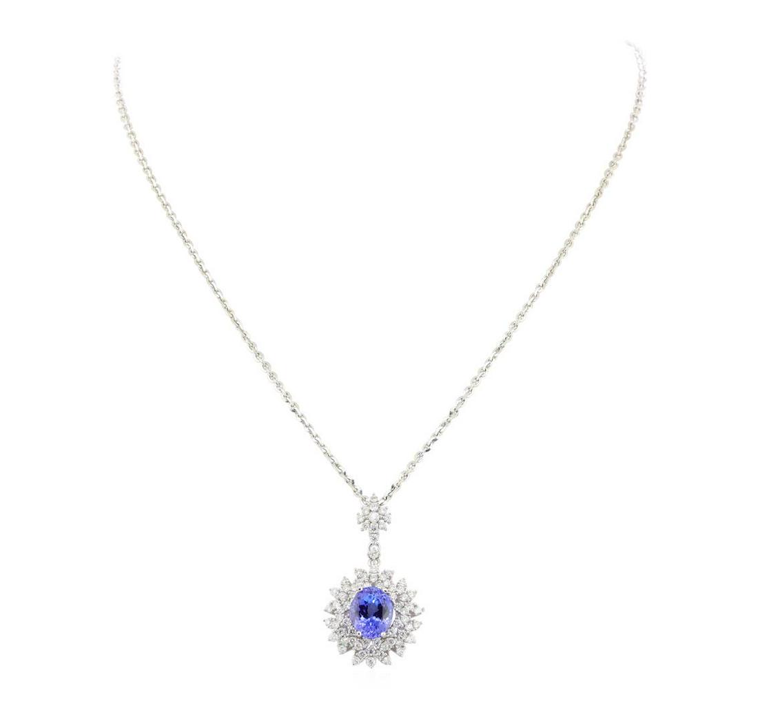 5.07 ctw Tanzanite and Diamond Pendant With Chain -: One electronically tested l4KT white gold ladies cast & assembled tanzanite and diamond pendant with chain. Condition is new, good workmanship. The pendant features a tanzanite set within a stylized ?