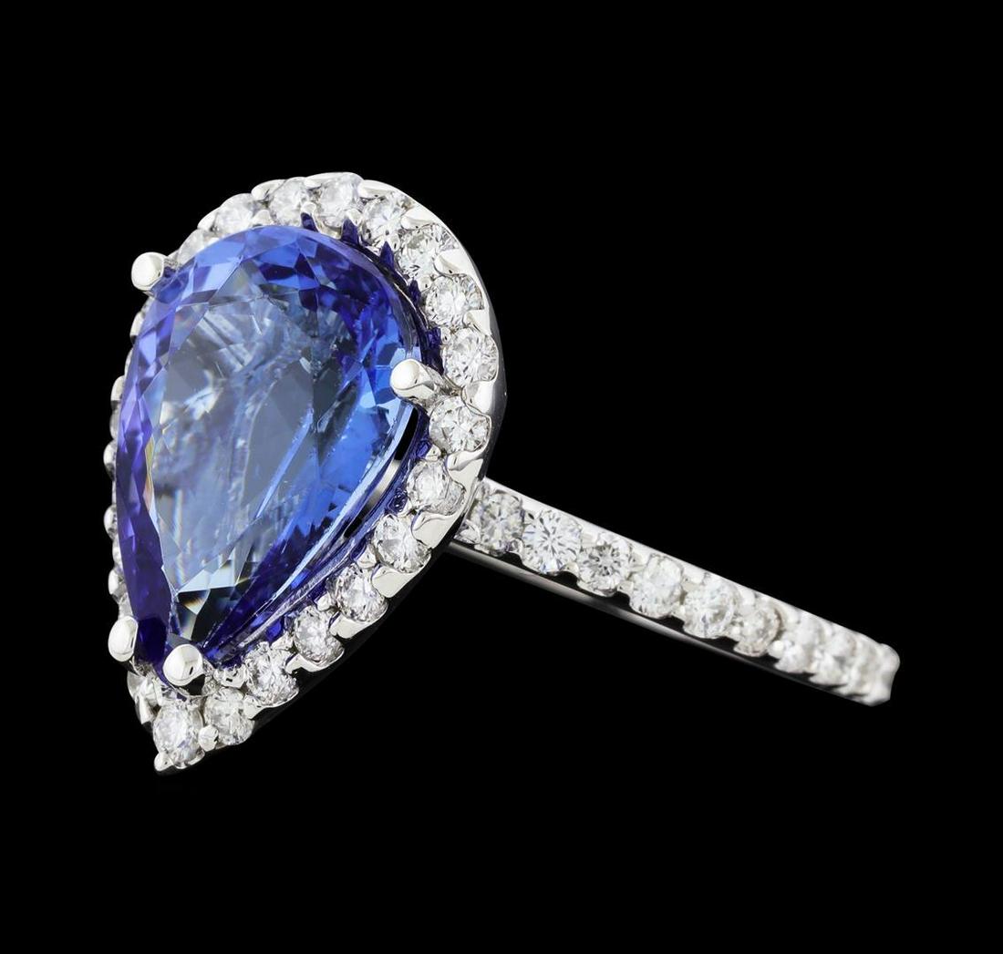 4.07 ctw Tanzanite and Diamond Ring - 14KT White Gold: One electronically tested 14KT white gold lady's cast fashion ring with a basket halo with a bright polish finish. The featured lady's ring has a shank measuring 1.74 millimeters wide. Identified with