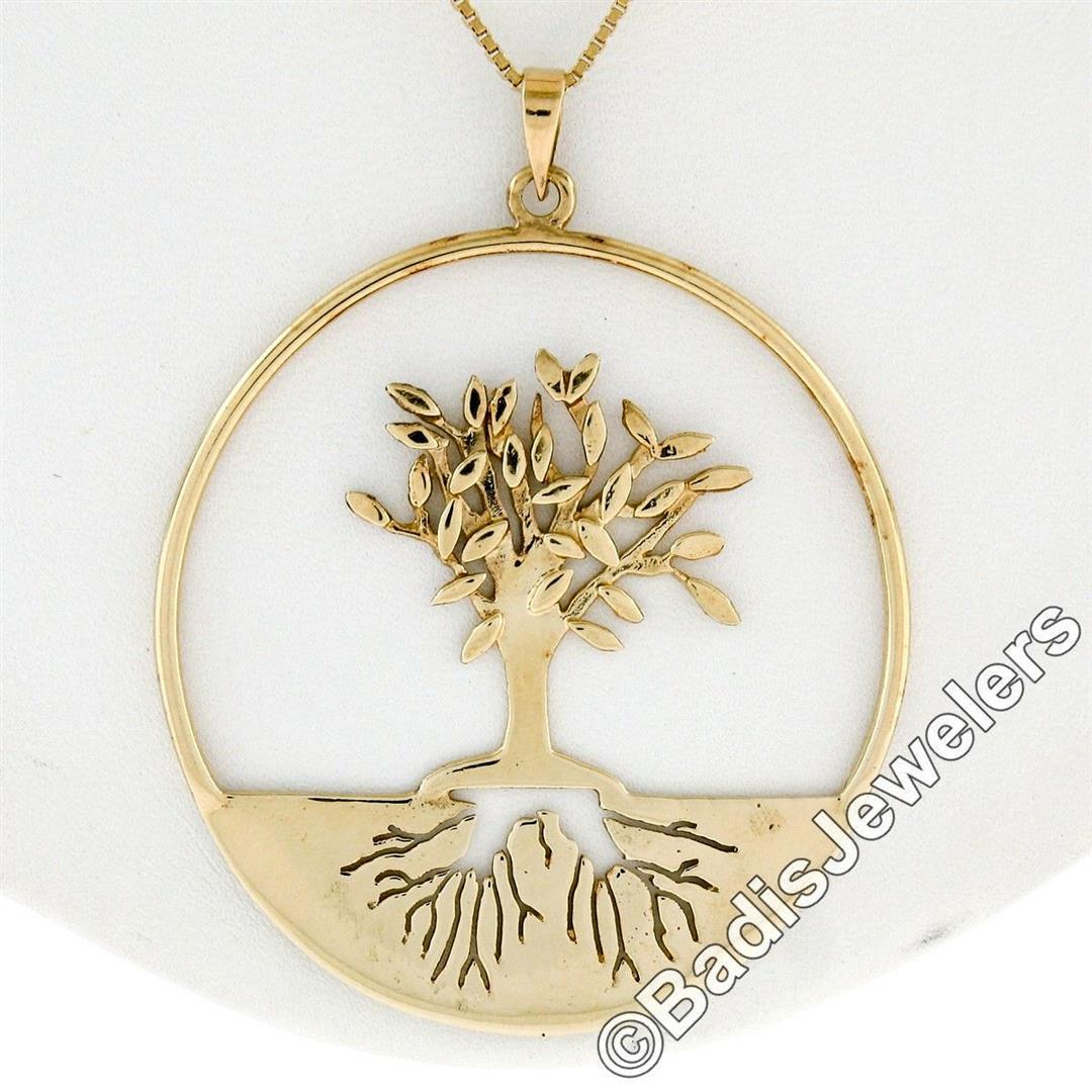 Vintage 14kt Yellow Gold Pierced and Textured Tree of: A large vintage 14kt yellow gold pendant necklace with a textured "Tree of Life" motif. Comes with a 24 inch box link chain, 12.2 grams total weight, pendant measures 59.00x46.45mm with the bail.