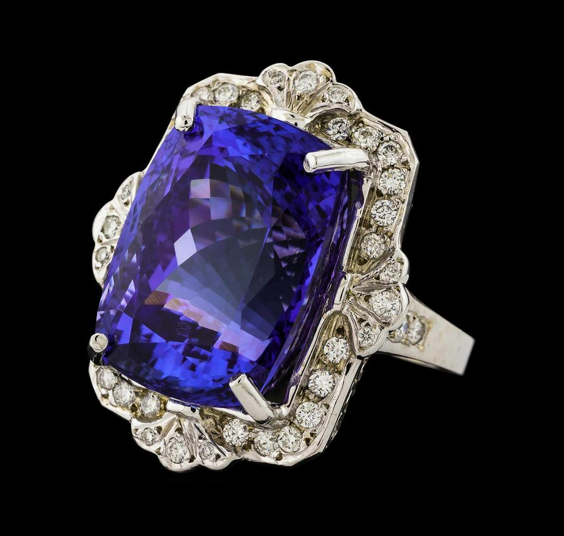 31.60 ctw Tanzanite and Diamond Ring - 14KT White Gold: One electronically tested 14KT white gold lady's cast fashion ring with a scalloped cathedral halo with a bright polish finish. The featured lady's ring has a shank measuring 2.45 millimeters wide. Id