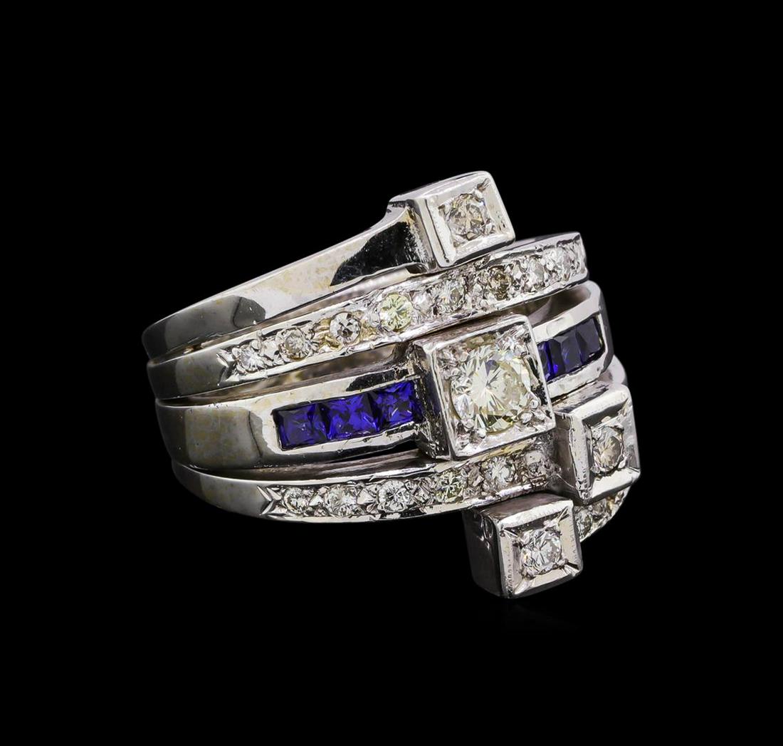 0.82 ctw Diamond and Sapphire Stackable Ring Set - 14KT: One electronically tested 14KT white gold ladies cast & assembled diamond and laboratory created sapphire stackable rings. The set contains three separate rings. The center ring features a diamond sup