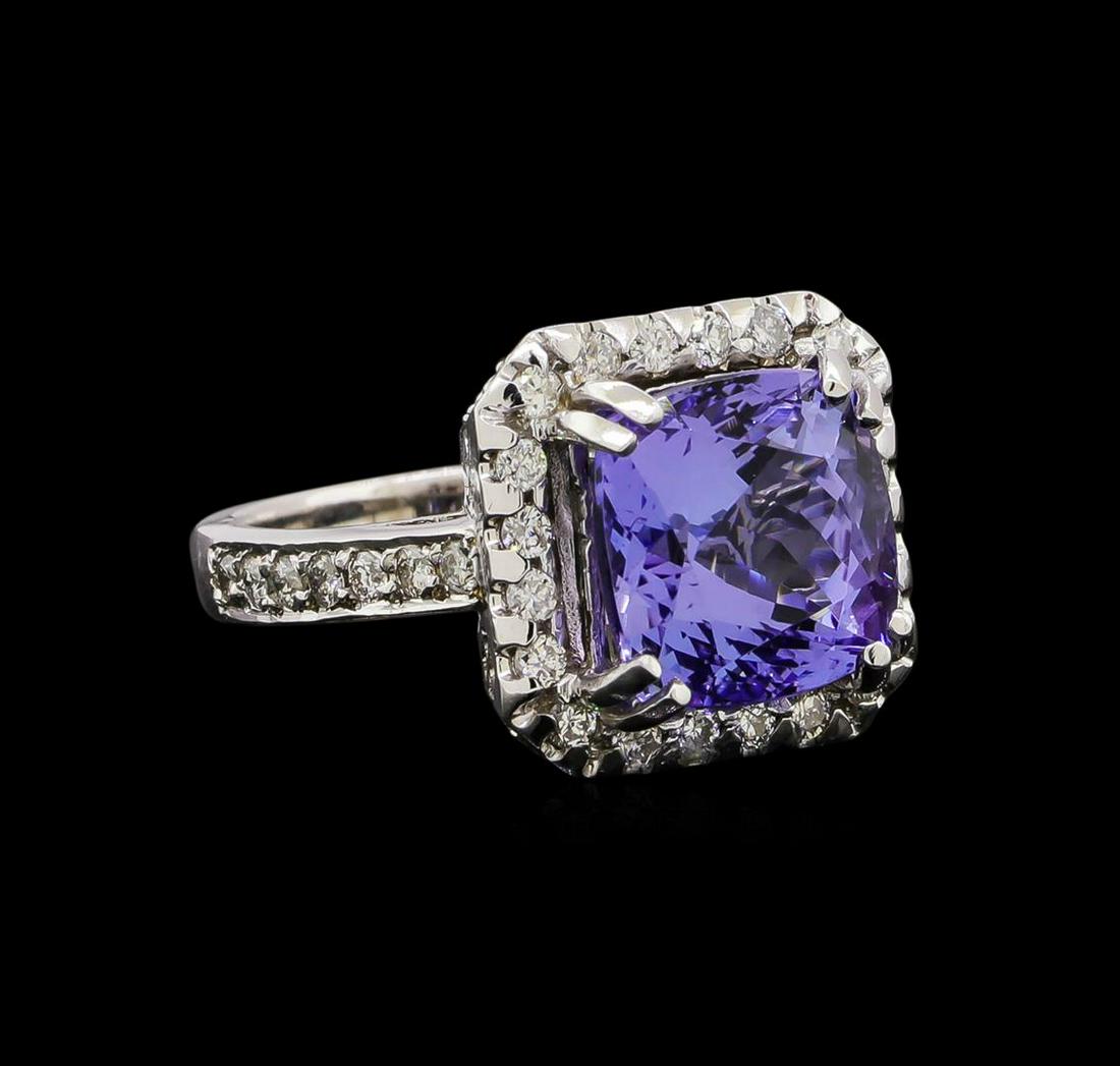 14KT White Gold 4.73 ctw Tanzanite and Diamond Ring: One electronically tested 14KT white gold ladies cast tanzanite and diamond ring with a bright polish finish. Identified with markings of "14K". Condition is new. Containing: One prong set square cush