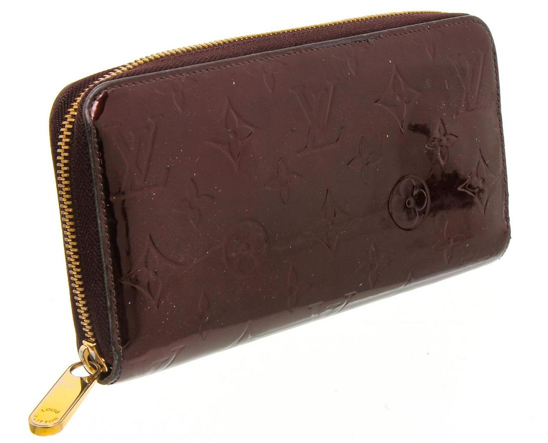 Louis Vuitton Amarante Vernis Monogram Zippy Wallet: Amarante Monogram Vernis leather Louis Vuitton Zippy wallet with brass hardware, tonal leather lining, four interior compartments; one with zip closure, three bill compartments, eight card slots and z