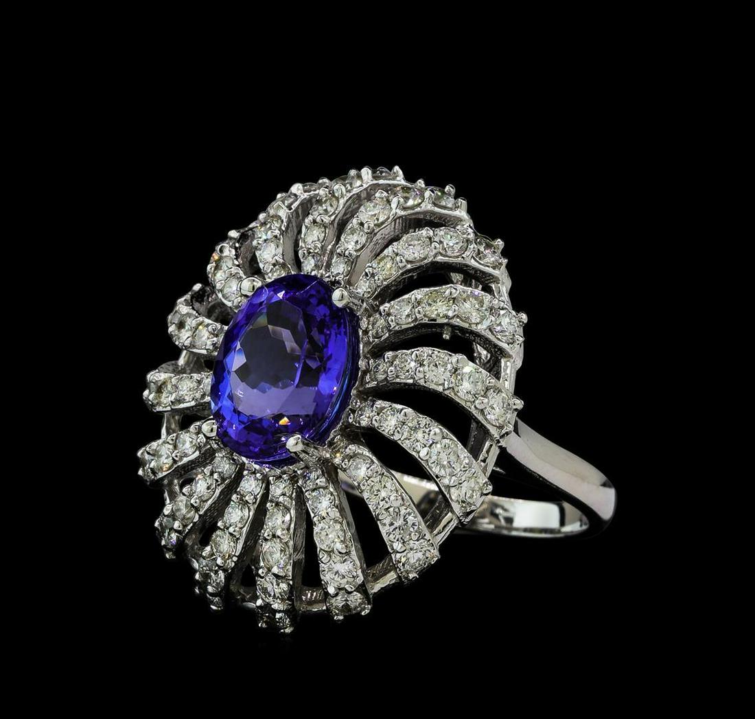 3.56 ctw Tanzanite and Diamond Ring - 14KT White Gold: One electronically tested 14KT white gold lady's cast fashion ring with a spiral halo with a bright polish finish. The featured lady's ring has a shank measuring 2.16 millimeters wide. Identified with