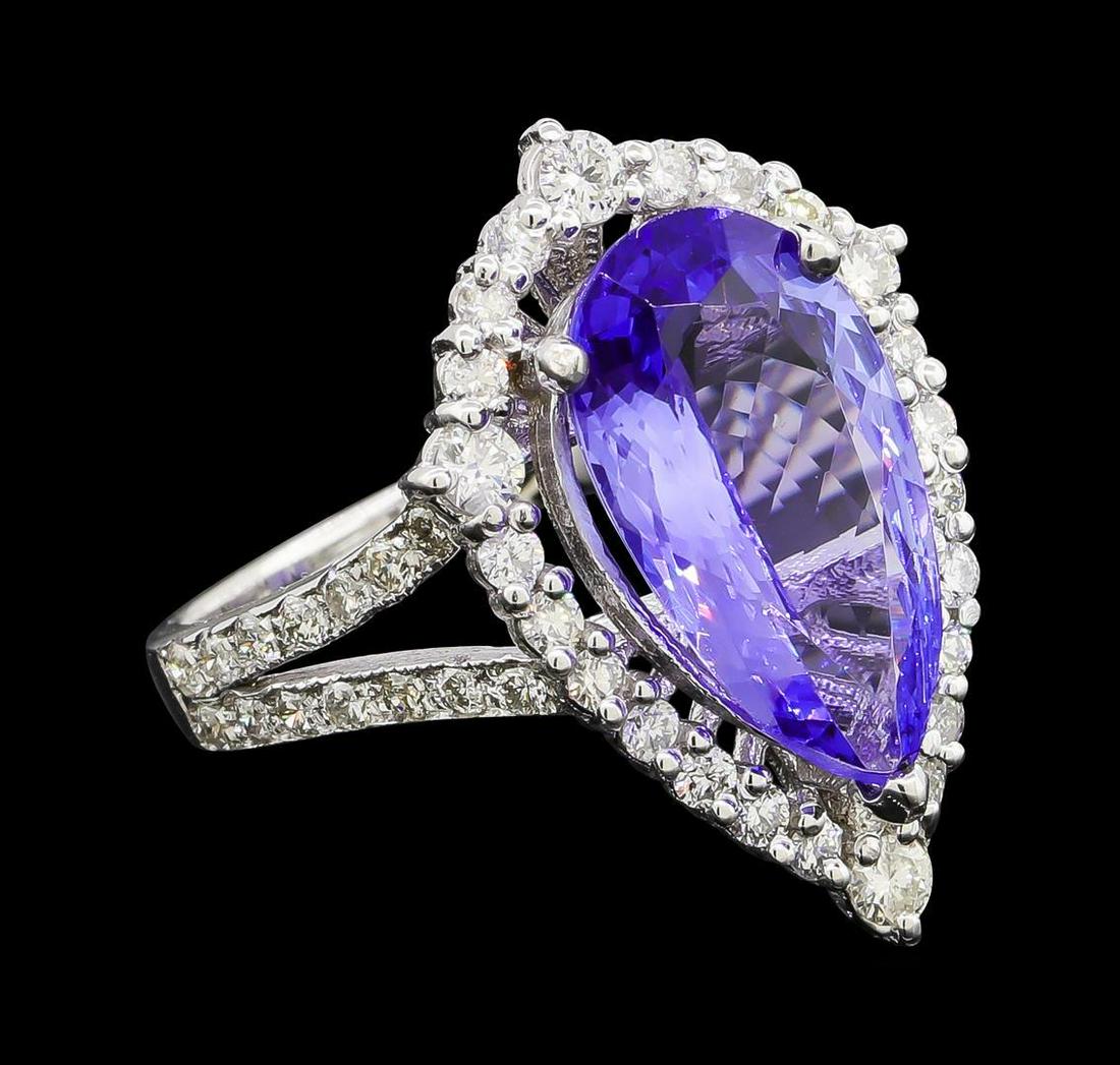 3.73 ctw Tanzanite and Diamond Ring - 14KT White Gold: One electronically tested 14KT white gold lady's cast fashion ring with a split shank basket halo with a bright polish with milgrain detailing finish. The featured lady's ring has a shank measuring 2.