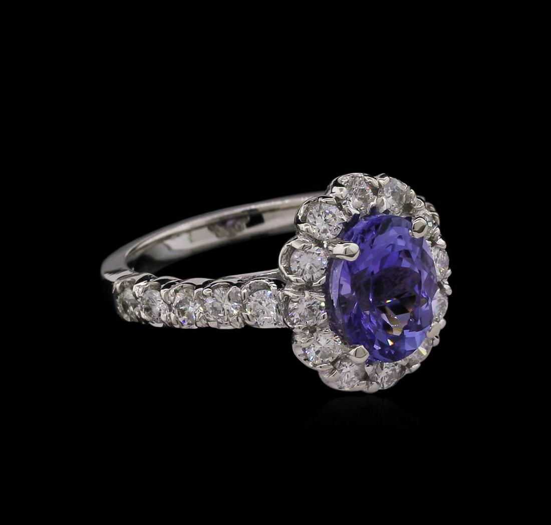 2.48 ctw Tanzanite and Diamond Ring - 14KT White Gold: One electronically tested 14KT white gold lady's cast fashion ring with a halo with a bright polish finish. The featured lady's ring has a shank measuring 2.27 millimeters in width. Identified with ma
