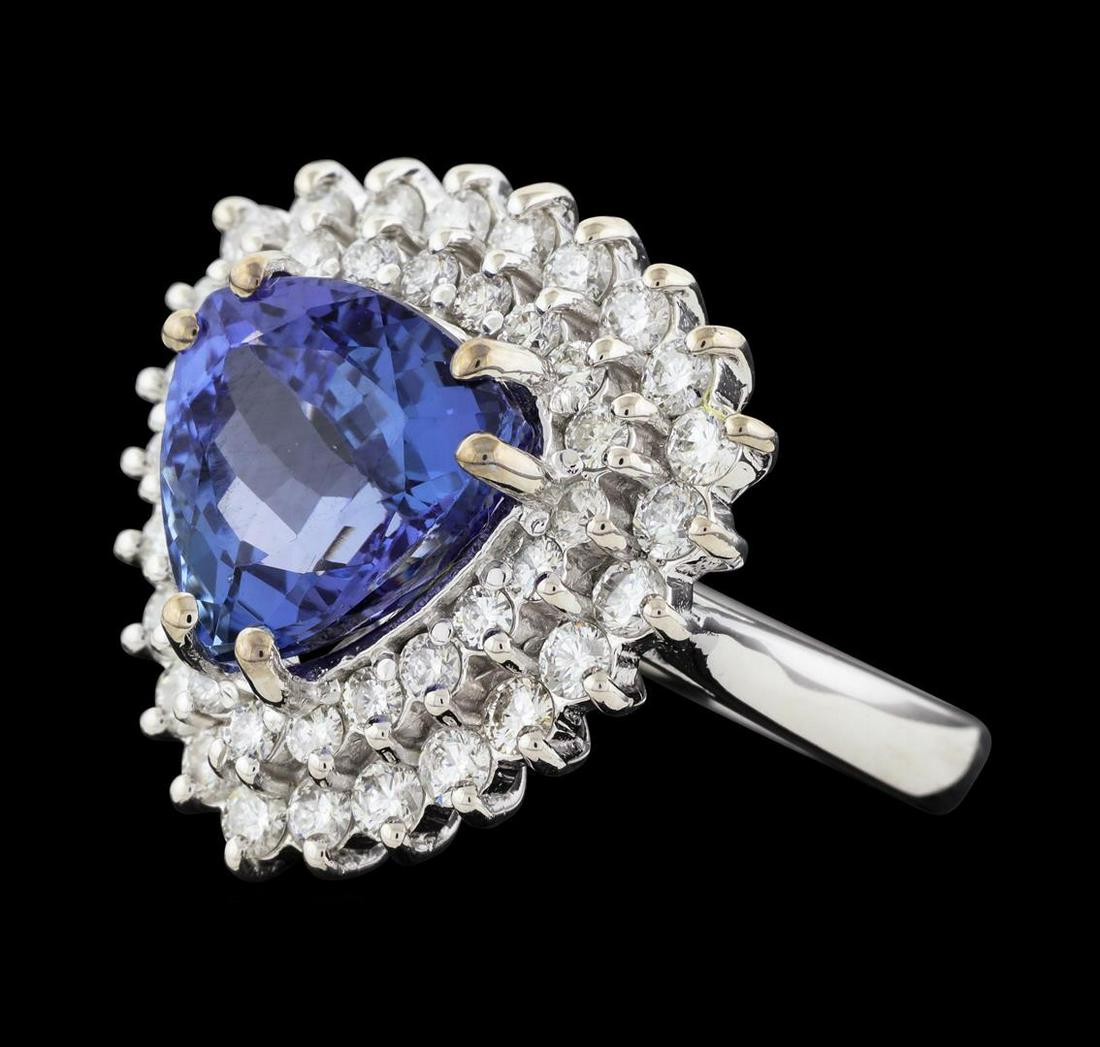 5.79 ctw Tanzanite and Diamond Ring - 14KT White Gold: One electronically tested 14KT white gold lady's cast fashion ring with a double basket halo with a bright polish finish. The featured lady's ring has a shank measuring 2.88 millimeters wide. Identifi