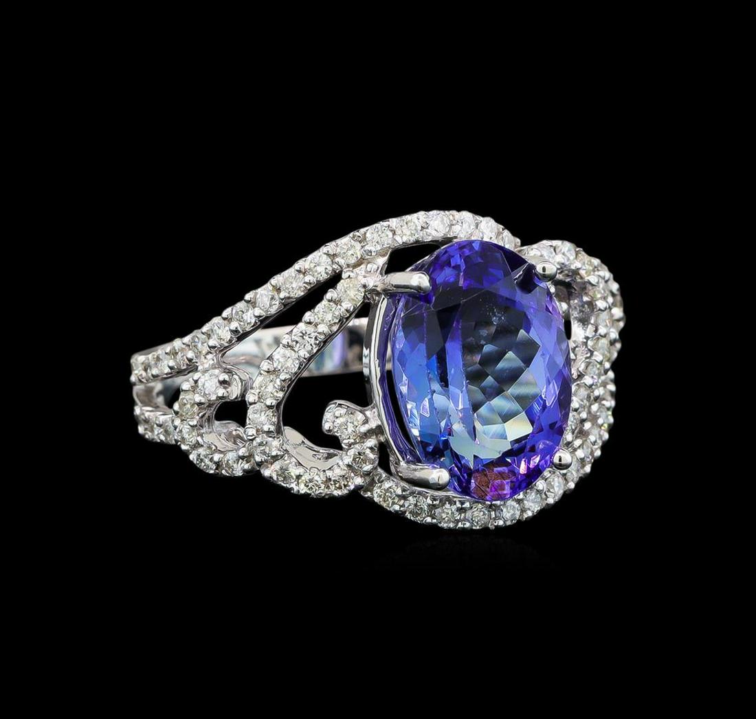 14KT White Gold 3.23 ctw Tanzanite and Diamond Ring: One electronically tested 14KT white gold ladies cast tanzanite and diamond ring with a bright polish finish. Identified with markings of "14K". Condition is new. Containing: One prong set oval modifi