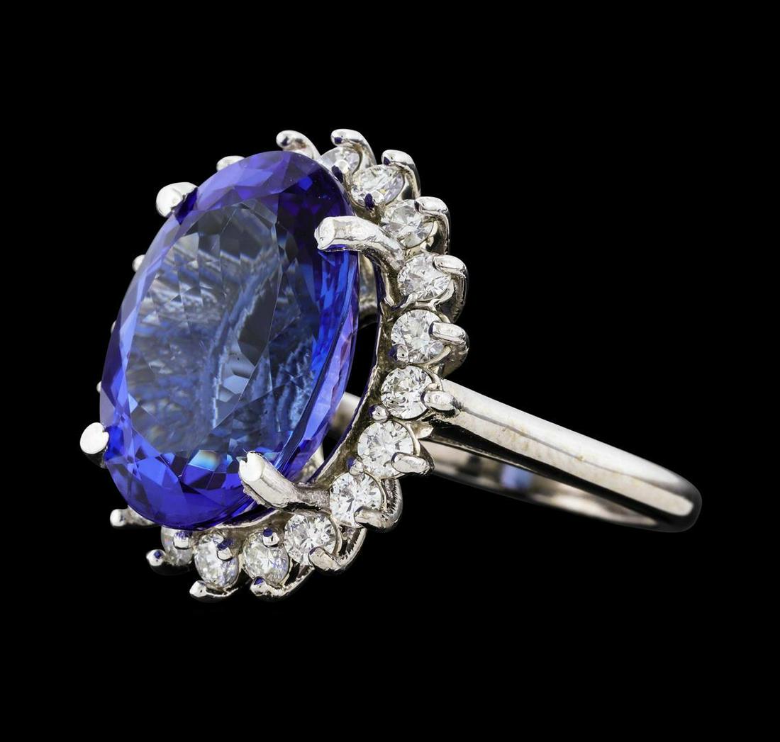 12.58 ctw Tanzanite and Diamond Ring - 14KT White Gold: One electronically tested 14KT white gold lady's cast fashion ring with a cathedral shank with a basket halo with a bright polish finish. The featured lady's ring has a shank measuring 2.09 millimeter