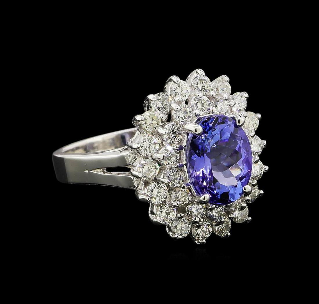 14KT White Gold 2.37 ctw Tanzanite and Diamond Ring: One electronically tested 14KT white gold ladies cast tanzanite and diamond ring with a bright polish finish. Identified with markings of "14K". Condition is new. Containing: One prong set oval modifi
