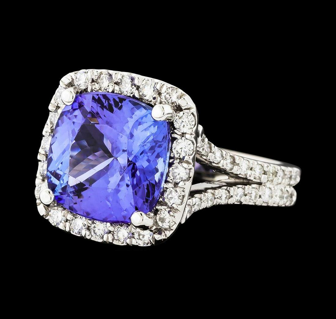 5.90 ctw Tanzanite and Diamond Ring - 14KT White Gold: One electronically tested 14KT white gold lady's cast fashion ring with a split shank halo with a bright polish finish. The featured lady's ring has a double shank measuring 3.31 millimeters wide. Ide