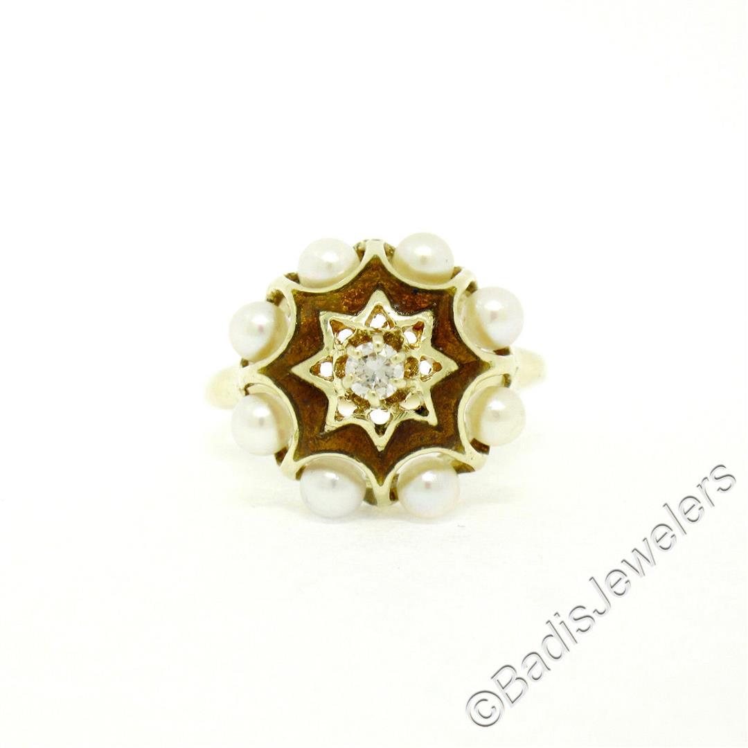 Vintage 14kt Yellow Gold 0.11 ctw Diamond and Pearl: An excellent condition vintage ring set with a 0.11ct round diamond (G - VS2) surrounded by halos of 3.5mm round cultured pearls and brown enamel work. The ring is size 6.5, weighs a total of 4.75 gra