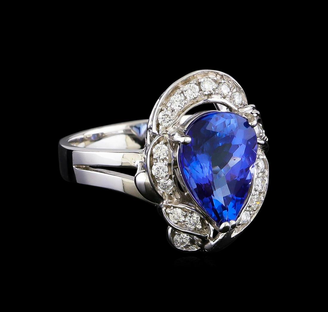 3.04 ctw Tanzanite and Diamond Ring - 14KT White Gold: One electronically tested 14KT white gold lady's ring has a shank measuring 3.42 millimeters in width. Containing: One pave' set pear modified brilliant cut natural tanzanite, measuring 11.50 x 8.15 x