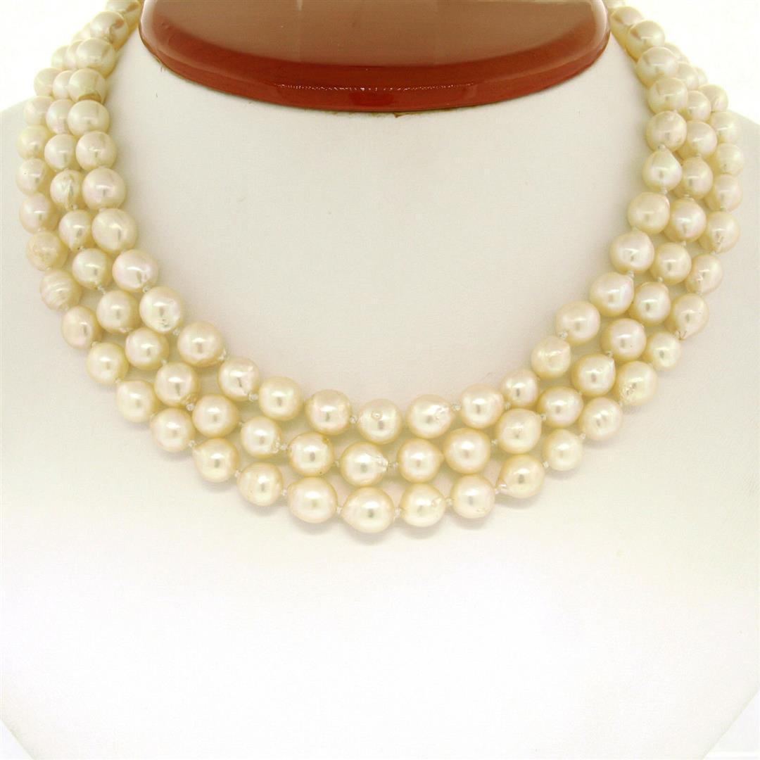 Three Strand Baroque Pearl 14" Choker Necklace w/ 14K: A vintage choker necklace featuring three strands of semi-baroque shaped cultured pearls (131, 7.0-7.5mm) connected with a wide solid 14k yellow gold filigree box clasp. 14 inches in length, 68.19 gra