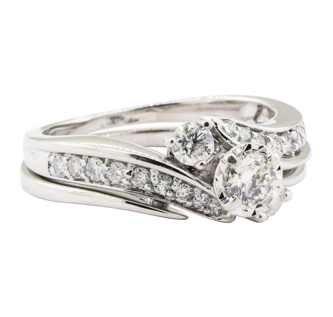 0.93 ctw Diamond Ring And Ring Guard - 10KT White Gold: One set electronically tested 10KT white gold lady's combination cast & assembled wedding ring and ring guard with a three stone bypass motif with a bright polish finish. The featured lady's ring set 