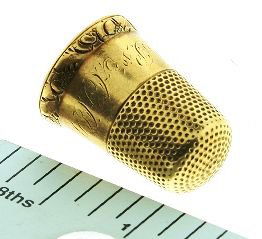 Vintage Gold Thimble with original leather casing: Vintage Gold Thimble with original leather casing - As-Is Condition Vintage Condition. Leather Box is very worn and broken in back. Thimble is in decent shape with small scratch wear, but free from de