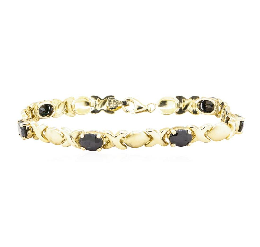 6.00 ctw Sapphire Bracelet - 10KT Yellow Gold: One "X's and O's" bracelet measuring approximately seven inches in length featuring: 10KT yellow gold weighign 6.8 grams containing six sapphires weighing 6.00 ctw.