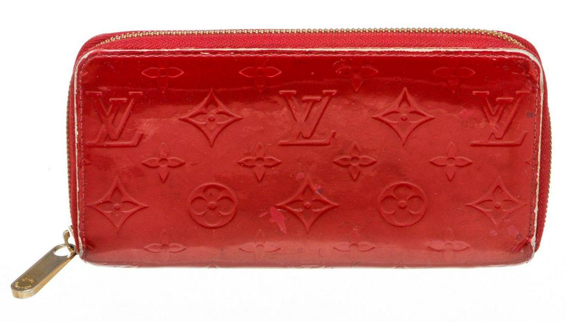 Louis Vuitton Red Vernis Monogram Zippy Wallet: Red Vernis leather Louis Vuitton Zippy wallet with gold-tone hardware, tonal leather lining, four interior compartments; one with zip closure, three bill compartments, eight card slots and zip-around