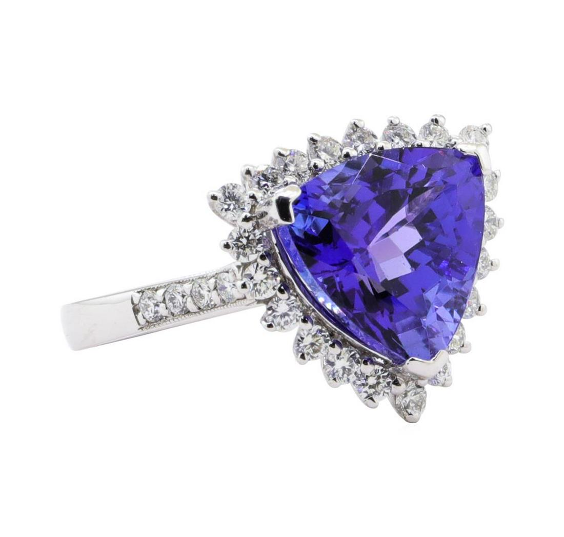 5.92 ctw Tanzanite and Diamond Ring - Platinum: One electronically tested platinum ladies cast tanzanite & diamond ring. The ring features a tanzanite set within a diamond floret, supported by a ribbed under gallery and diamond set shoulders, compl