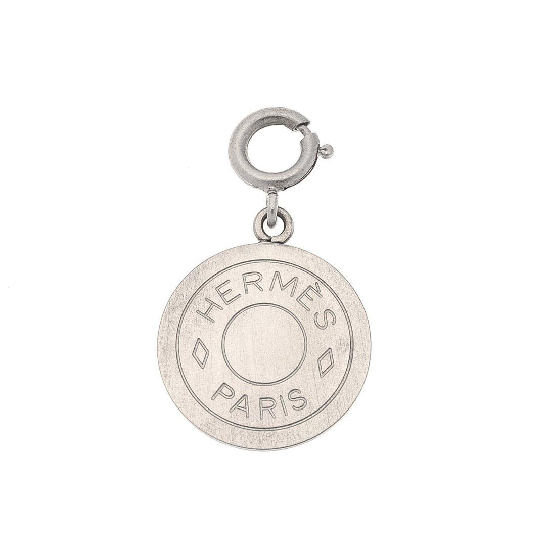 Hermes Silver Clou de Selle Pendant: Hermes Silver Clou de Selle Pendant with silver-tone hardware. Measurements: Length: 0.5 in / 1 cm CONDITION: Pre-Owned Good overall, please see photographs for detail.