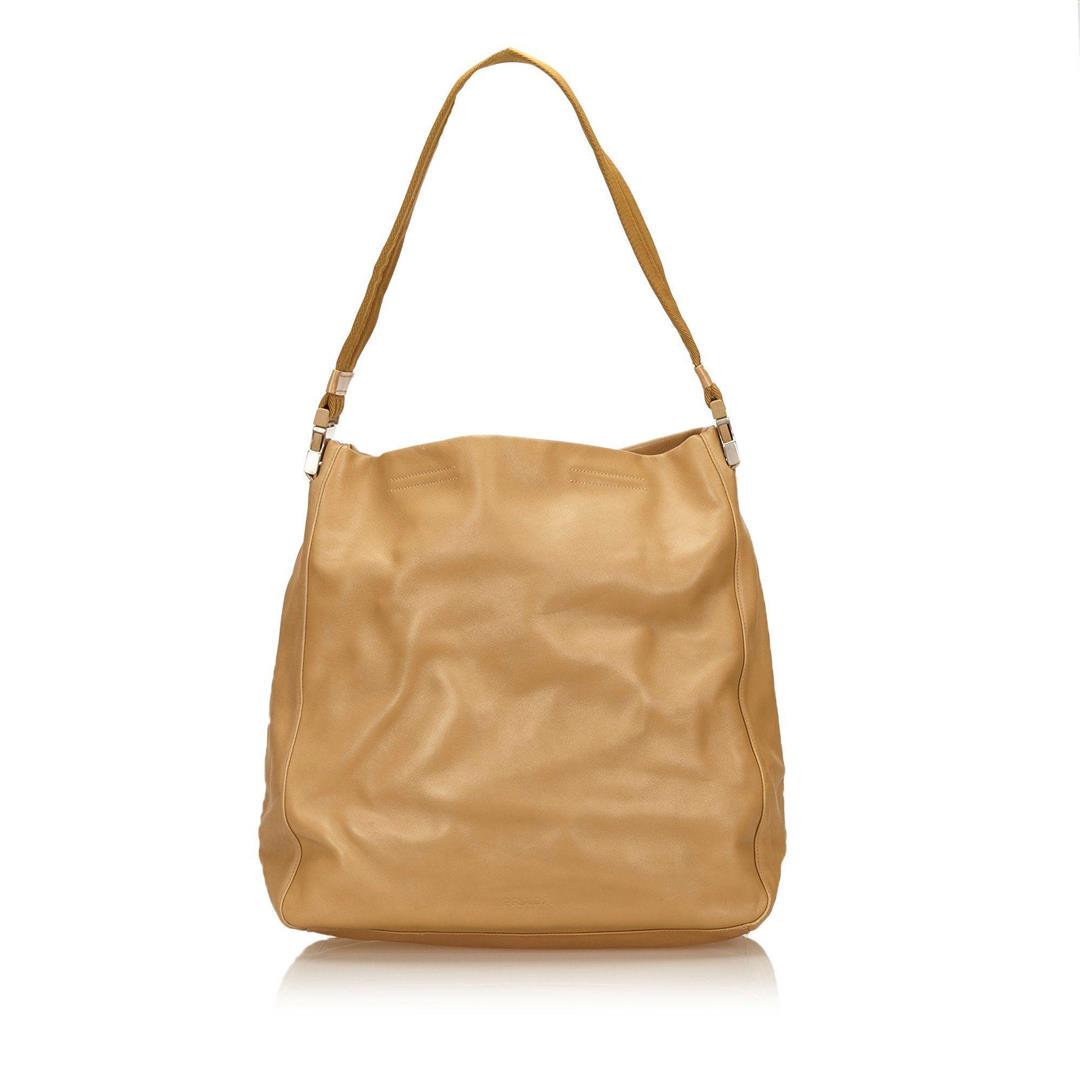 Prada Leather Shoulder Bag: This shoulder bag features a leather body, a flat shoulder strap, an open top, and an interior zip pocket. Measurements: Length: 30 in / 76 cm Width: 32 in / 81 cm 14 in / 36 cmCONDITION: Pre-Owned Go