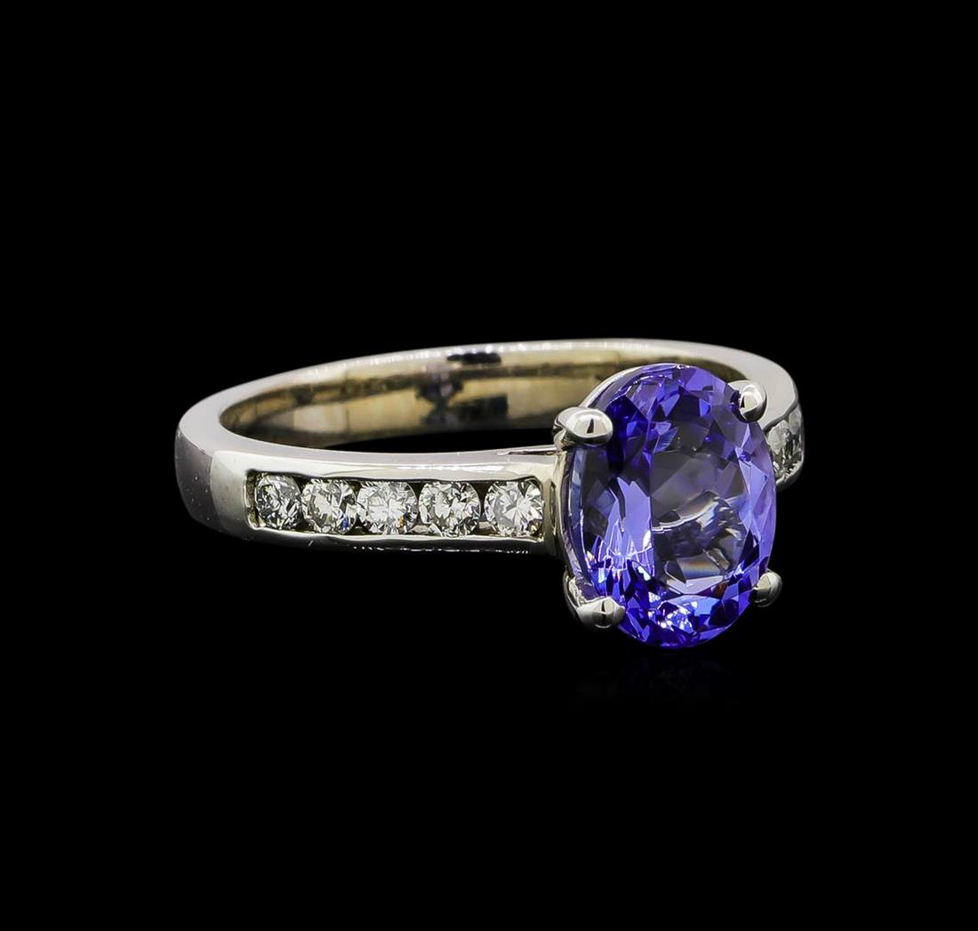 14KT White Gold 2.07 ctw Tanzanite and Diamond Ring: One electronically tested 14KT white gold ladies cast tanzanite and diamond ring. Identified with markings of "14K". Condition is new. Containing: One prong set oval modified brilliant cut natural tan