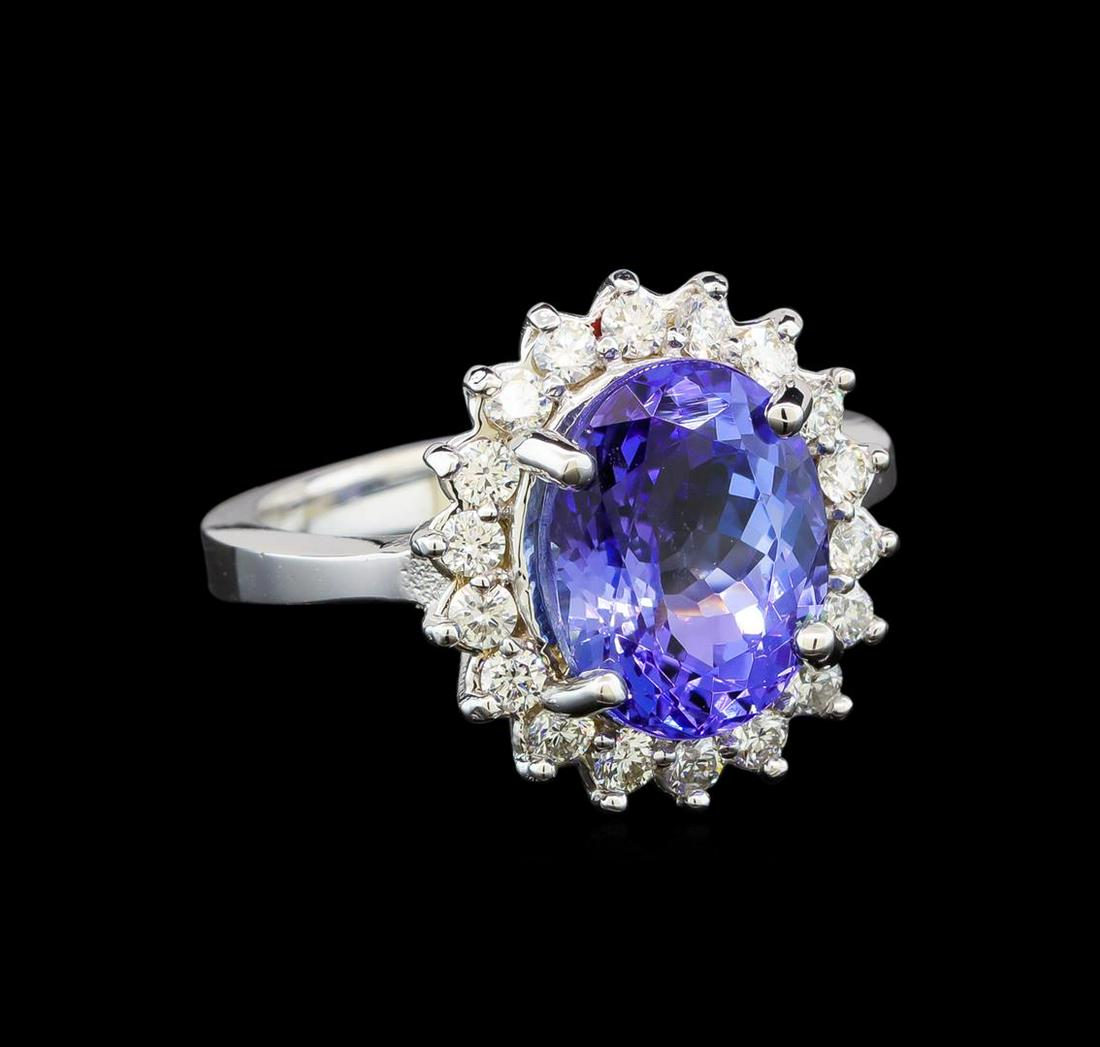 14KT White Gold 3.87 ctw Tanzanite and Diamond Ring: One electronically tested 14KT white gold ladies cast tanzanite and diamond ring with a bright polish finish. Identified with markings of "K14". Condition is new. Containing: One prong set oval modifi