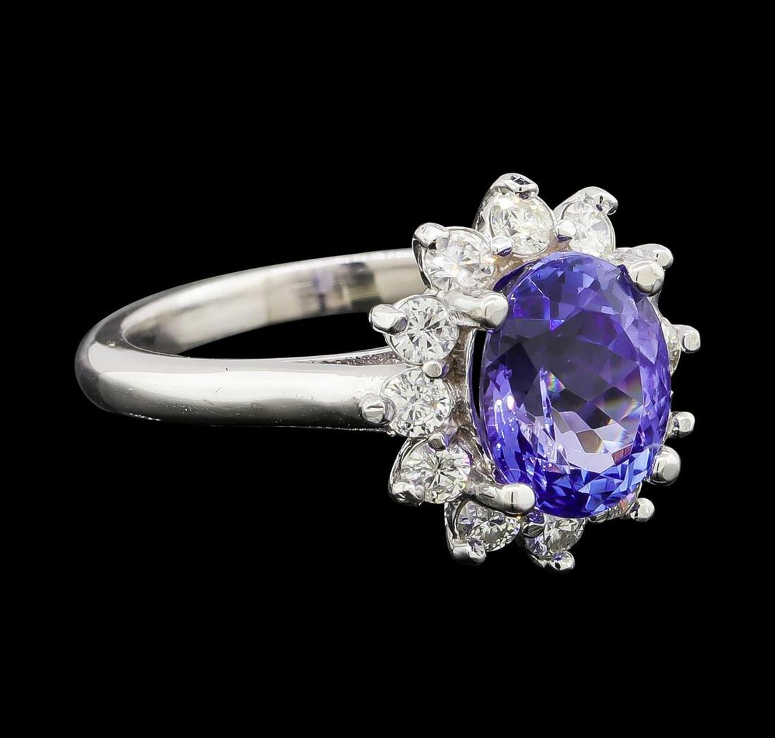 2.70 ctw Tanzanite and Diamond Ring - 14KT White Gold: One electronically tested 14KT white gold lady's cast fashion ring with a basket halo with a bright polish finish. The featured lady's ring has a shank measuring 2.14 millimeters wide. Identified with
