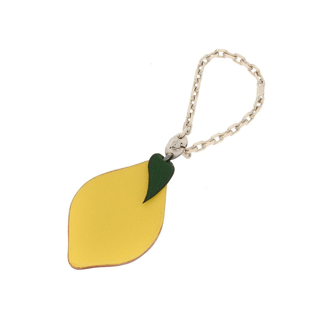 Hermes Yellow Leather Lemon Chain Key Charm Bag: Hermes Yellow Leather Lemon Chain Key Charm Bag with gold-tone hardware, Chain Key Charm. Measurements: Length: 8.5 in / 22 cm Width: 2 in / 5 cm 11.5 in / 29 cmCONDITION: Pre-Owned Good overall, plea
