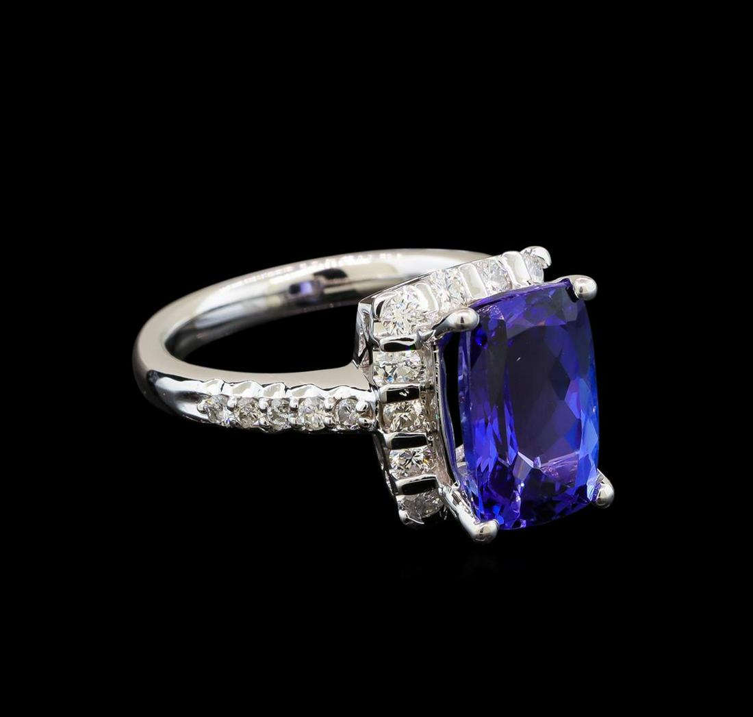 14KT White Gold 3.17 ctw Tanzanite and Diamond Ring: One electronically tested 14KT white gold ladies cast tanzanite and diamond ring with a bright polish finish. Identified with markings of "14K". Condition is new. Containing: One prong set rectangular