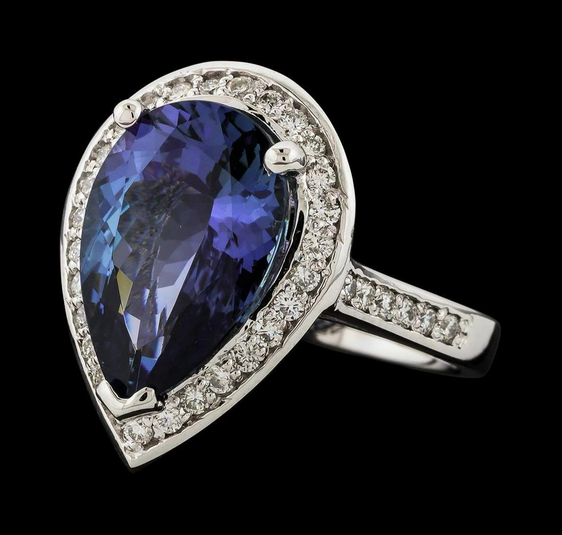 6.87 ctw Tanzanite and Diamond Ring - 14KT White Gold: One electronically tested 14KT white gold lady's cast fashion ring with a cathedral shank with a basket halo with a bright polish finish. The featured lady's ring has a shank measuring 2.70 millimeter