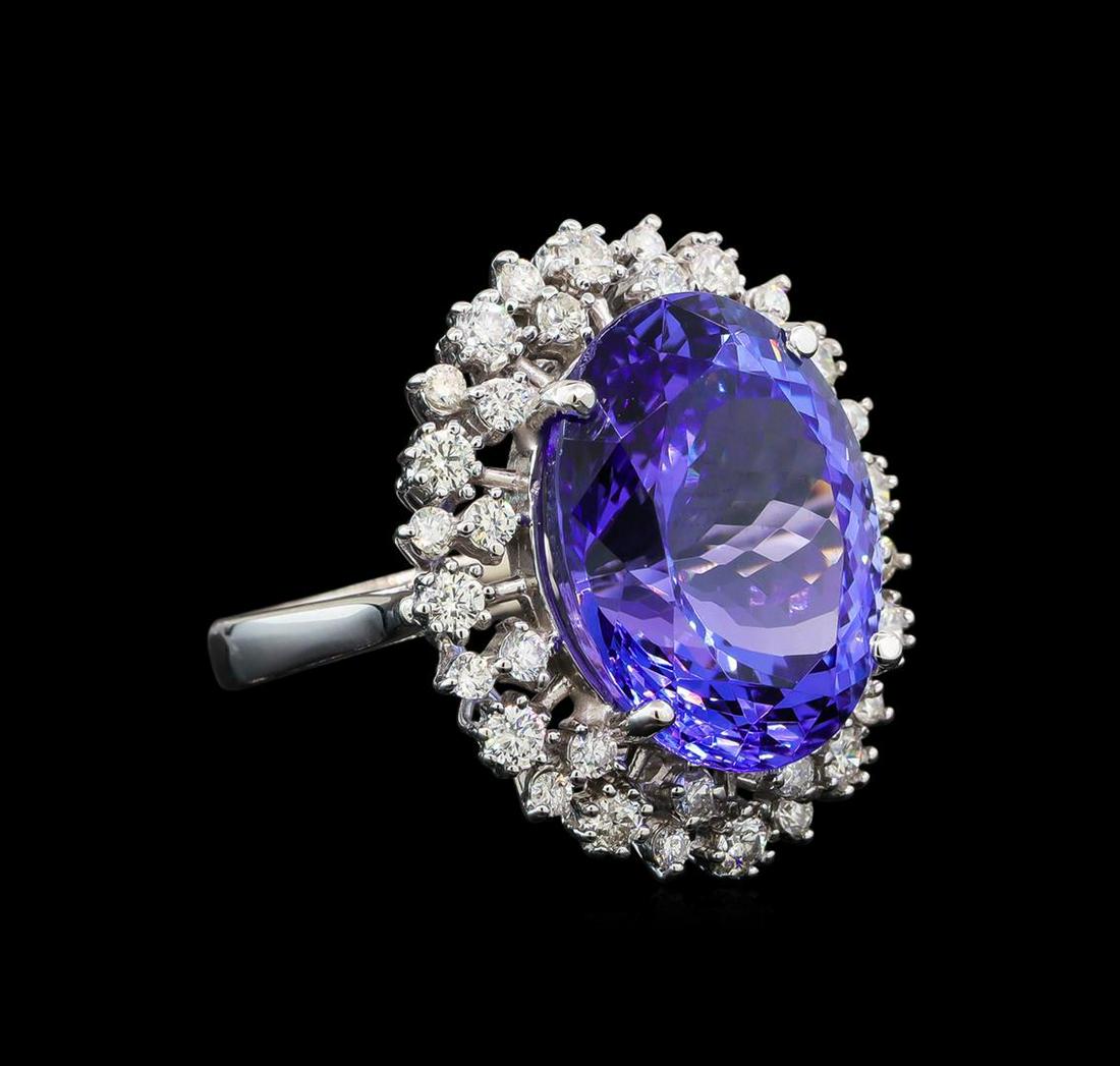 GIA Cert 16.94 ctw Tanzanite and Diamond Ring - 14KT: One electronically tested 14KT white gold lady's cast fashion ring with a double basket halo with a bright polish finish. The featured lady's ring has a shank measuring 2.59 millimeters wide. Identifi