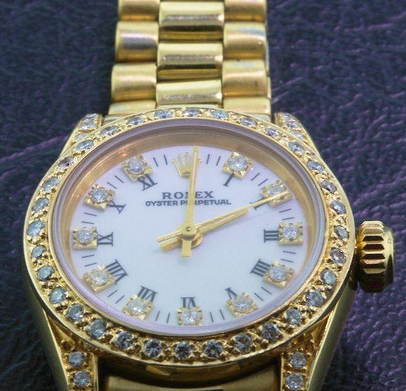 Ladies 18KTY Gold Rolex Oyster Perpetual A378 Wri: Ladies 18KTY Gold Rolex Oyster Perpetual A378 Wristwatch - Amazing Watch - 66.63 gm - Circa 1989. Numerous round brilliant cut diamonds adorn this watch =.88cts. Comes with a Full Appraisal letter fro