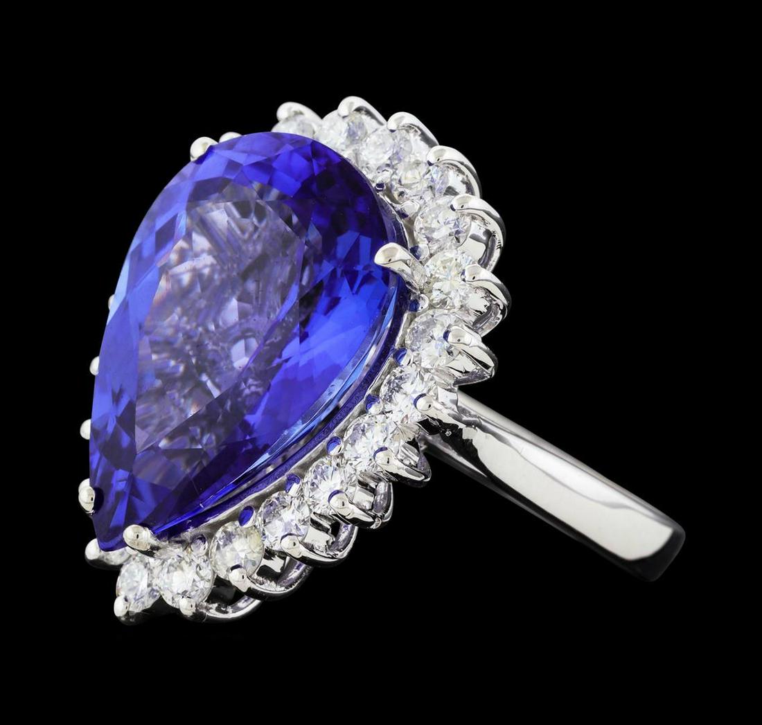 12.77 ctw Tanzanite and Diamond Ring - 14KT White Gold: One electronically tested 14KT white gold lady's cast fashion ring with a basket halo with a bright polish finish. The featured lady's ring has a shank measuring 2.82 millimeters wide. Identified with