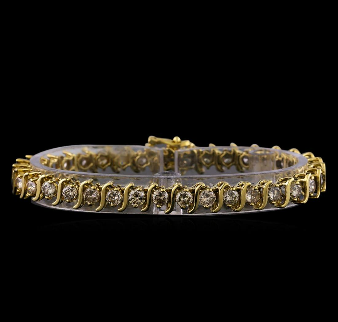 7.13 ctw Diamond Bracelet - 14KT Yellow Gold: One electronically tested 14KT yellow gold ladies cast & assembled 'S' link style diamond tennis bracelet with a bright polish finish. Seven inch length bracelet composed of a flexible ribbon of diamo