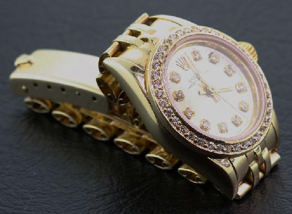 Ladies 18KTY Rolex Oyester Perpetual A374 Wristwatc: Ladies 18KTY Rolex Oyester Perpetual A374 Wristwatch - Amazing Watch - 54.83 gm - 14Kt Yellow Gold. Contains 38 round brillant cut diamonds = 0.44ct. Comes with a Full Appraisal letter from AIG. Value