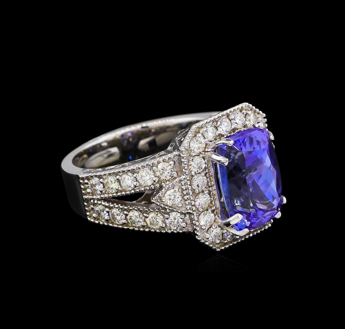 4.25 ctw Tanzanite and Diamond Ring - 14KT White Gold: One electronically tested 14KT white gold lady's cast fashion ring with a split shank halo with a bright polish with milgrain detailing finish. The featured lady's ring has a shank measuring 4.18 mill