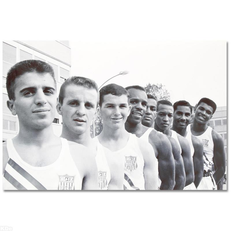 Ali with USA Olympians by Ali, Muhammad: Own a piece of sports history with this Muhammad Ali photo with fellow Olympians. Taken at the peak of his success as one of the greatest heavyweight championship boxers of all time, this photo is sur