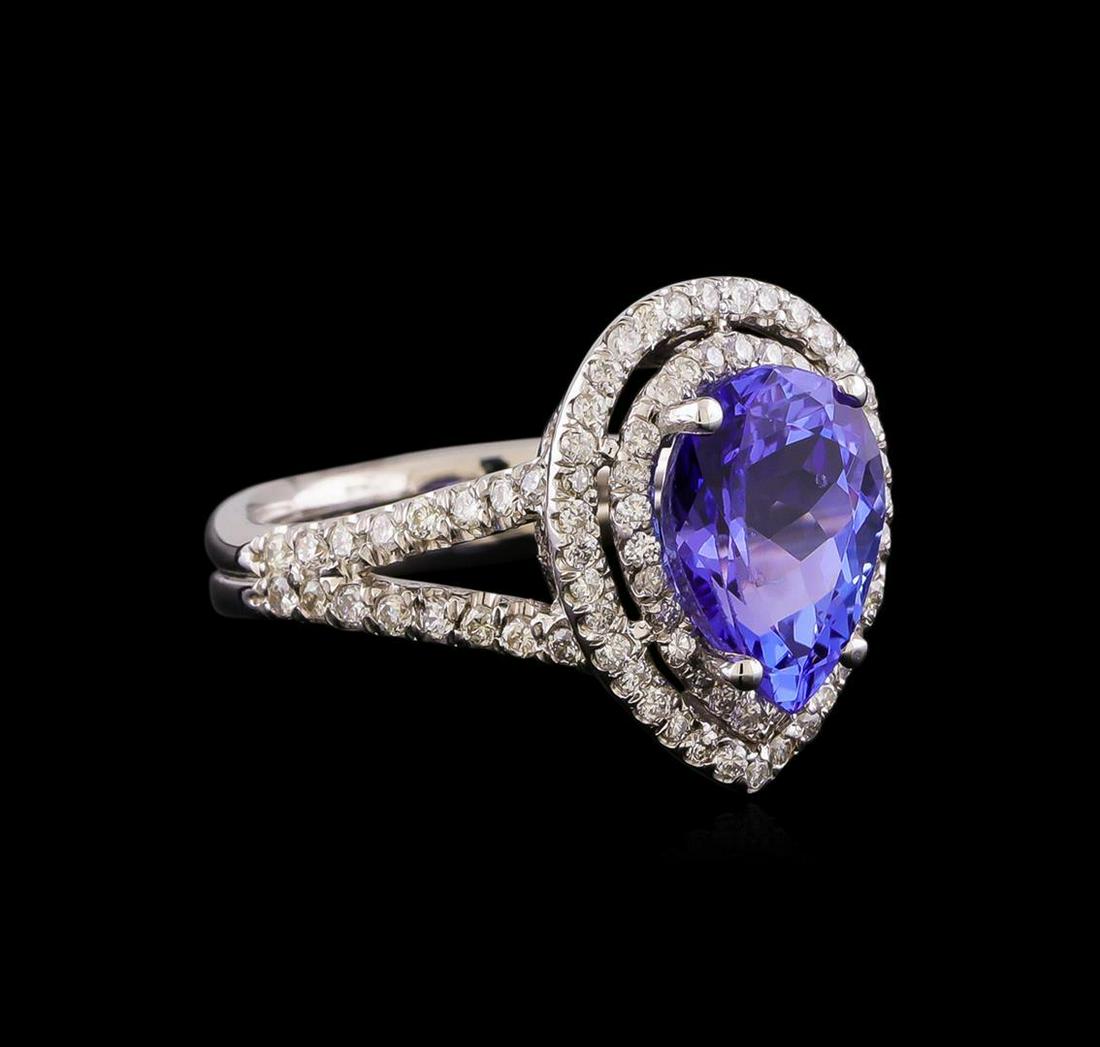 3.15 ctw Tanzanite and Diamond Ring - 14KT White Gold: One electronically tested 14KT white gold lady's cast fashion ring with a split shank double halo with a bright polish finish. The featured lady's ring has a double shank measuring 4.01 millimeters wi