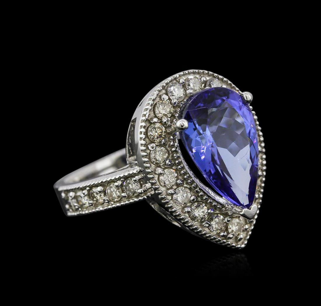 14KT White Gold 4.12 ctw Tanzanite and Diamond Ring: One electronically tested 14KT white gold ladies cast tanzanite and diamond ring with a cathedral shank with a bright polish finish. Identified with markings of "K14". Condition is new. Containing: On