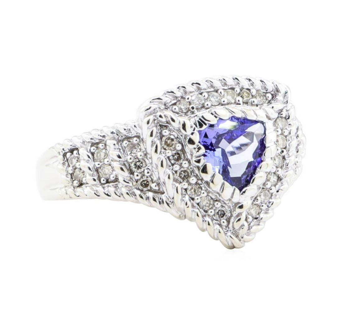 1.15 ctw Tanzanite And Diamond Ring - 14KT White Gold: One electronically tested 14KT white gold lady's cast fashion halo ring with a tapered shank with a bright polish finish. The featured lady's ring has twisted wire accents and a shank measuring 2.85 m