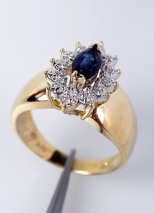 10KT Yellow Gold Ladies Sapphire & Diamond Ring A664: 10KT Yellow Gold Ladies Sapphire & Diamond Ring A664 Excellent Condition! One 10KT yellow gold ladies cast sapphire and diamond ring. The featured sapphire is set within a diamond bezel and completed