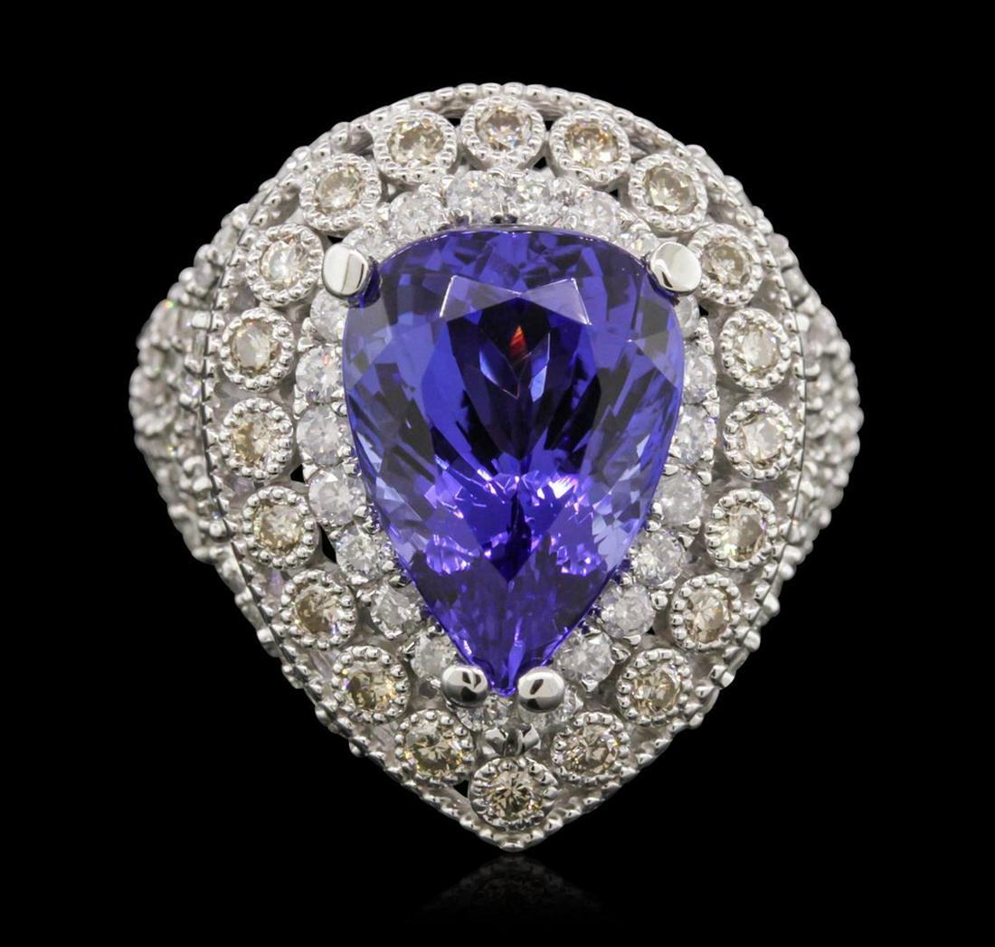14KT White Gold 9.78 ctw Tanzanite and Diamond Ring: One electronically tested 14KT white gold cast tanzanite & diamond ring with a bright & patterned finish. The featured tanzanite is set within an elaborate multi-tiered diamond bezel, supported by dia