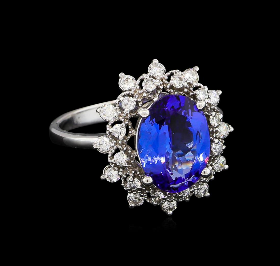 3.08 ctw Tanzanite and Diamond Ring - 14KT White Gold: One electronically tested 14KT white gold lady's cast fashion ring with a basket double halo with a bright polish with milgrain detailing finish. The featured lady's ring has a shank measuring 2.40 mi