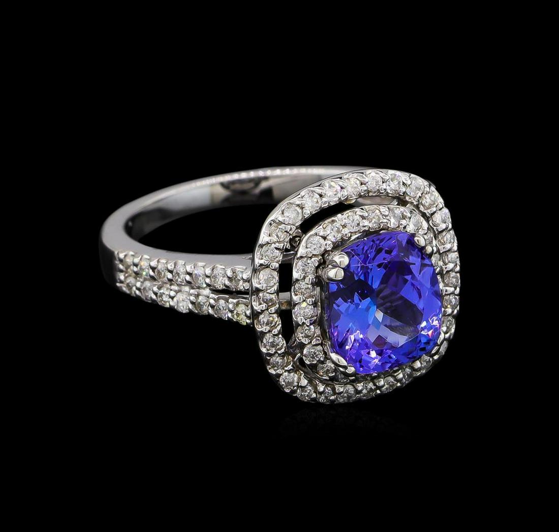 2.05 ctw Tanzanite and Diamond Ring - 14KT White Gold: One electronically tested 14KT white gold lady's cast fashion ring with a split shank double halo with a bright polish finish. The featured lady's ring has a shank measuring 2.14 millimeters wide. Ide