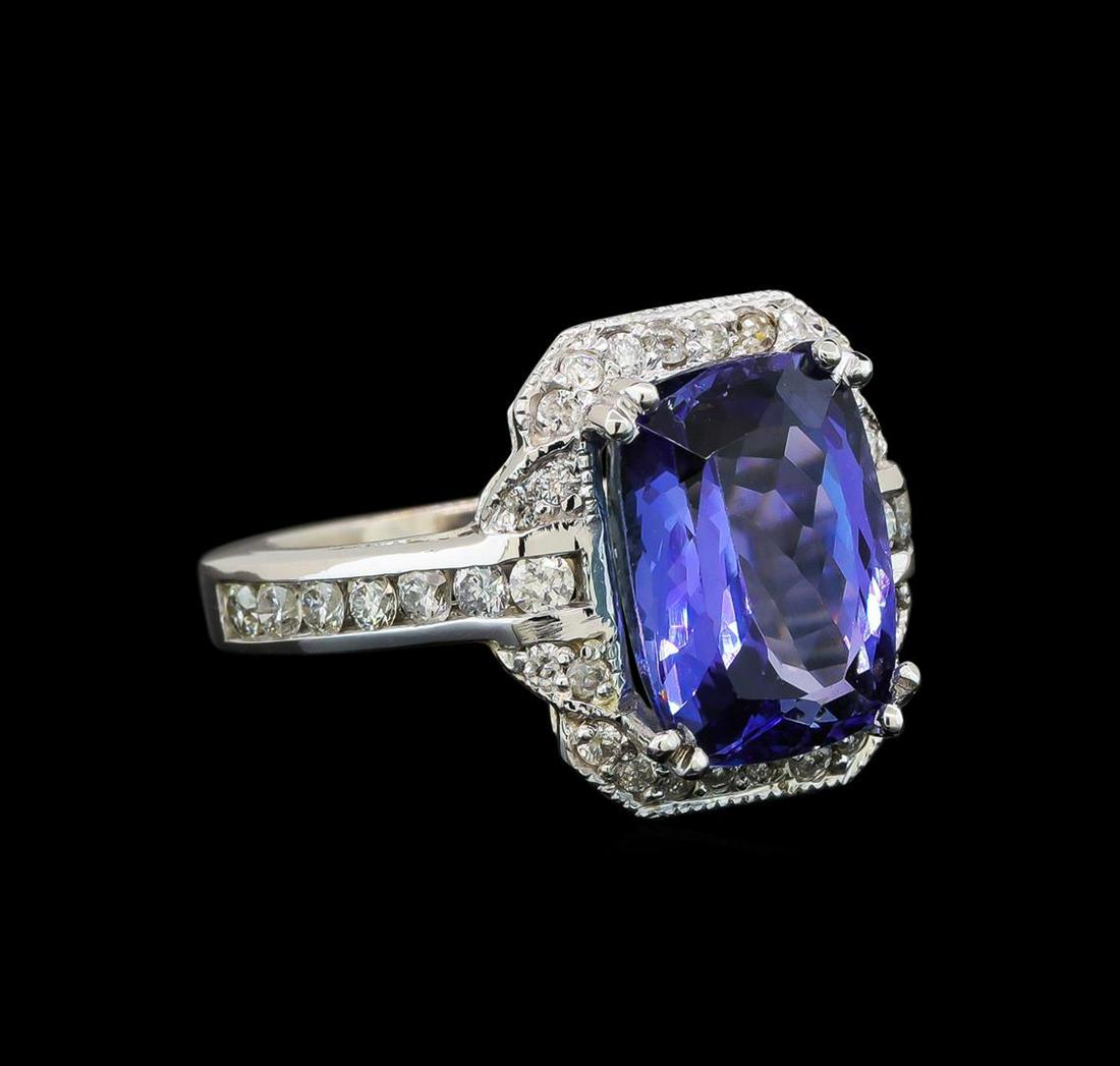 14KT White Gold 5.42 ctw Tanzanite and Diamond Ring: One electronically tested 14KT white gold ladies cast tanzanite and diamond ring with a bright polish finish. Identified with markings of "14K". Condition is new. Containing: One prong set rectangular