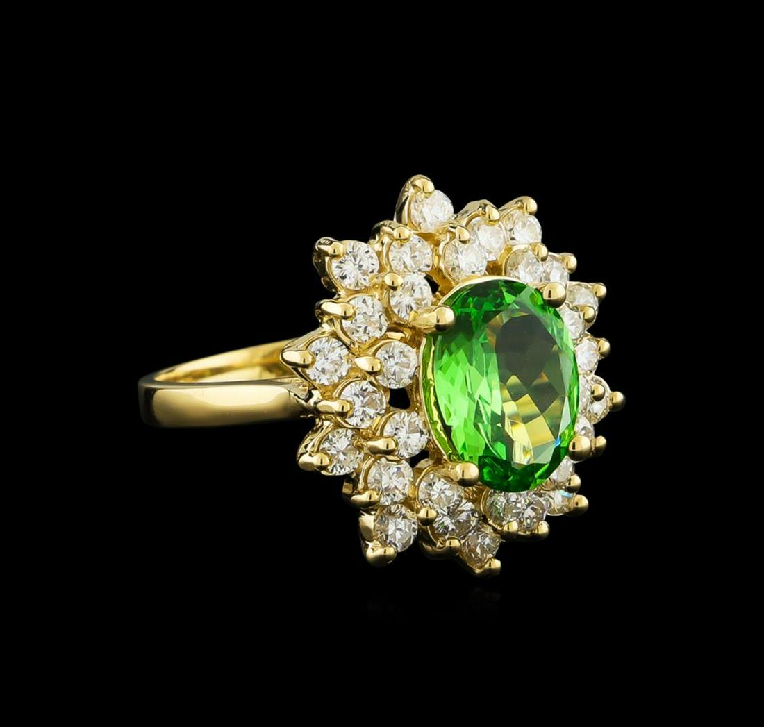 2.00 ctw Tsavorite and Diamond Ring - 14KT Yellow Gold: One electronically tested 14KT yellow gold lady's cast fashion ring with a double basket halo with a bright polish finish. The featured lady's ring has a shank measuring 2.05 millimeters wide. Identif