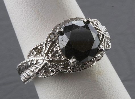 Black & White Diamond Ring 7.10 grams A396: Black & White Diamond Ring 7.10 grams A396 - Excellent Condition. Diamond 3.55ctw. Comes will FULL LETTER from AIG. See Scan. Valued at $7,150.00. - Thank you for viewing this lot. We are always addin