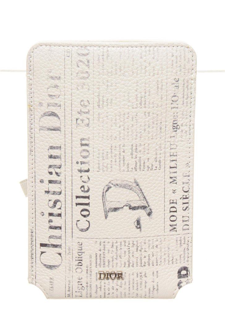Christian Dior White Leather Daniel Arsham Iphone: Christian Dior White Leather Daniel Arsham Iphone with leather, silver-tone hardware, single adjustable shoulder strap, tonal leather lining, single slit pocket at interior wall and push-lock closure